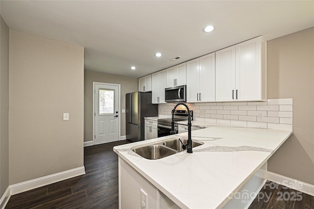 446 Mint St, Rock Hill, SC 29730 - kitchen featuring appliances with stainless steel finishes, baseboards, white cabinets, dark wood-type flooring, and recessed lighting