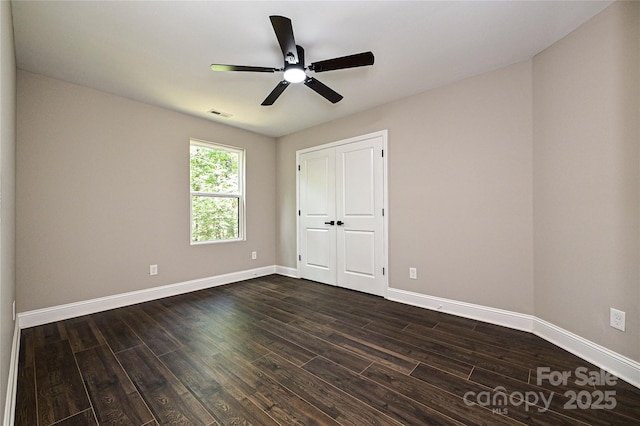446 Mint St, Rock Hill, SC 29730 - unfurnished bedroom featuring dark wood finished floors, baseboards, a ceiling fan, and a closet
