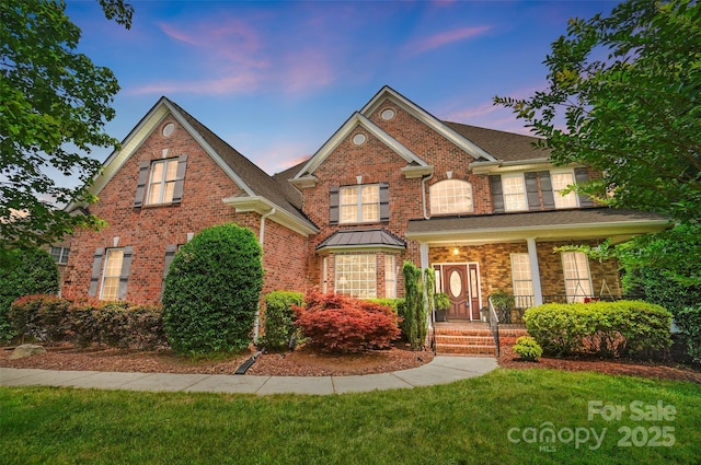 5916 Four Wood Dr, Matthews, NC 28104 - view of front of home with brick siding, a front yard, and covered porch