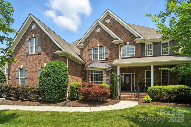 5916 Four Wood Dr, Matthews, NC 28104 - view of front of house with brick siding, covered porch, a front yard, and a shingled roof