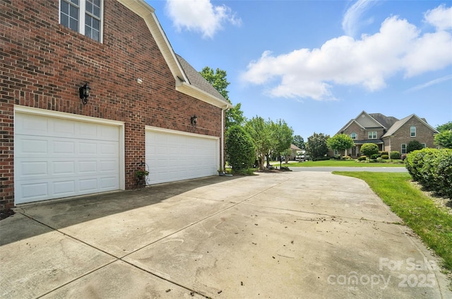 5916 Four Wood Dr, Matthews, NC 28104 - view of property exterior featuring driveway, brick siding, an attached garage, and a residential view