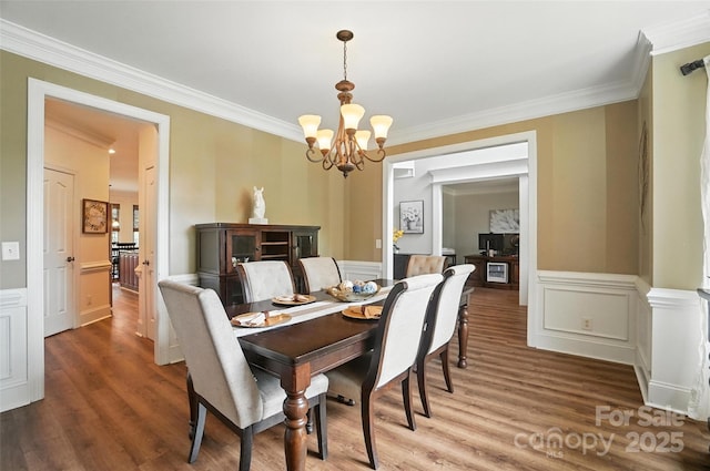 5916 Four Wood Dr, Matthews, NC 28104 - dining room with a chandelier, ornamental molding, wood finished floors, a decorative wall, and wainscoting