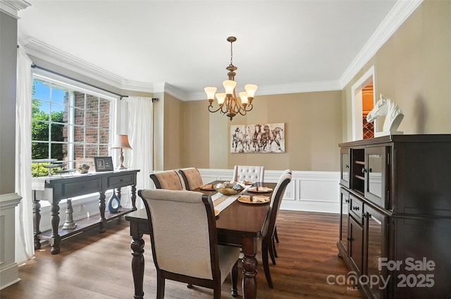 5916 Four Wood Dr, Matthews, NC 28104 - dining area with a chandelier, ornamental molding, dark wood-style floors, a wainscoted wall, and a decorative wall