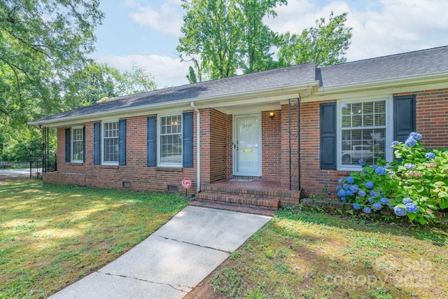 5720 Amity Pl, Charlotte, NC 28212 - ranch-style home with brick siding, a front yard, crawl space, and a shingled roof