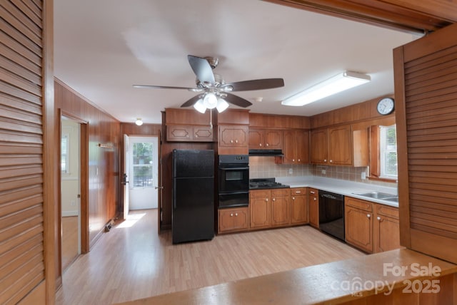 5720 Amity Pl, Charlotte, NC 28212 - kitchen with black appliances, a warming drawer, light wood-style floors, tasteful backsplash, and healthy amount of natural light
