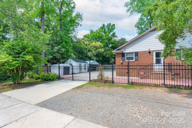 5720 Amity Pl, Charlotte, NC 28212 - view of front of house with brick siding, driveway, a fenced front yard, and a gate
