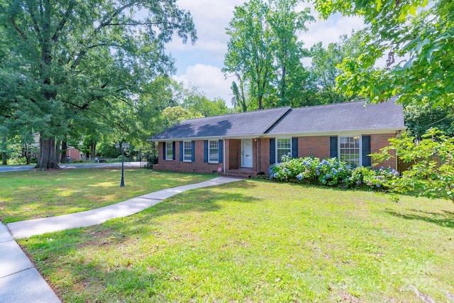 5720 Amity Pl, Charlotte, NC 28212 - ranch-style home with brick siding, a front yard, and a shingled roof