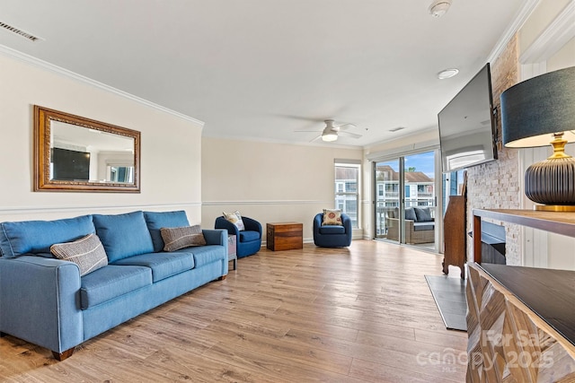 1038 SW Dr, Davidson, NC 28036 - living area with wood finished floors, crown molding, ceiling fan, and a fireplace