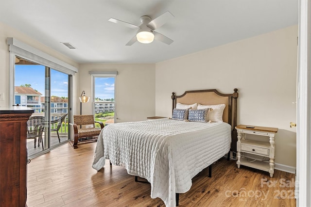 1038 SW Dr, Davidson, NC 28036 - bedroom with access to exterior, wood finished floors, and a ceiling fan