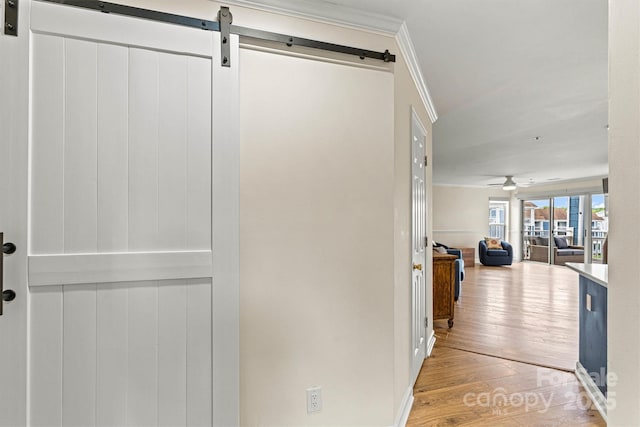 1038 SW Dr, Davidson, NC 28036 - hallway featuring a barn door, light wood finished floors, and crown molding