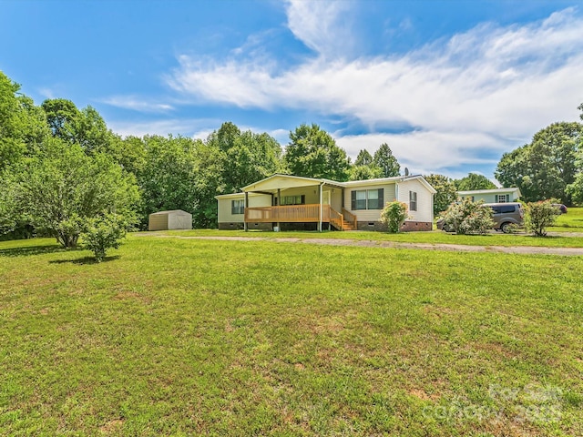 4591 Scott Rd, Morganton, NC 28655 - manufactured / mobile home featuring crawl space, a front lawn, a deck, and a detached carport