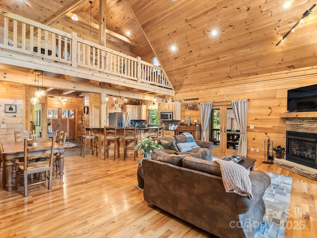 1526 Pisgah Preserve Dr Unit 7-8, Nebo, NC 28761 - living room featuring wooden ceiling, wood walls, light wood-type flooring, a stone fireplace, and high vaulted ceiling