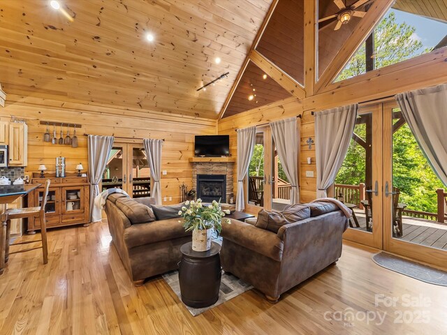 1526 Pisgah Preserve Dr Unit 7-8, Nebo, NC 28761 - living area featuring french doors, high vaulted ceiling, light wood-type flooring, wood ceiling, and wooden walls