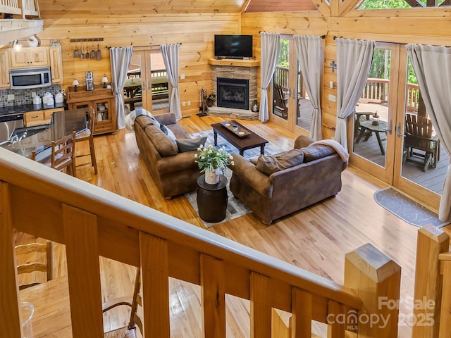 1526 Pisgah Preserve Dr Unit 7-8, Nebo, NC 28761 - living area featuring light wood-style flooring, wooden walls, and a fireplace