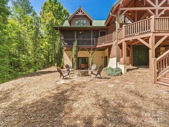 1526 Pisgah Preserve Dr Unit 7-8, Nebo, NC 28761 - rear view of house with a fire pit, stucco siding, a metal roof, a ceiling fan, and a wooden deck