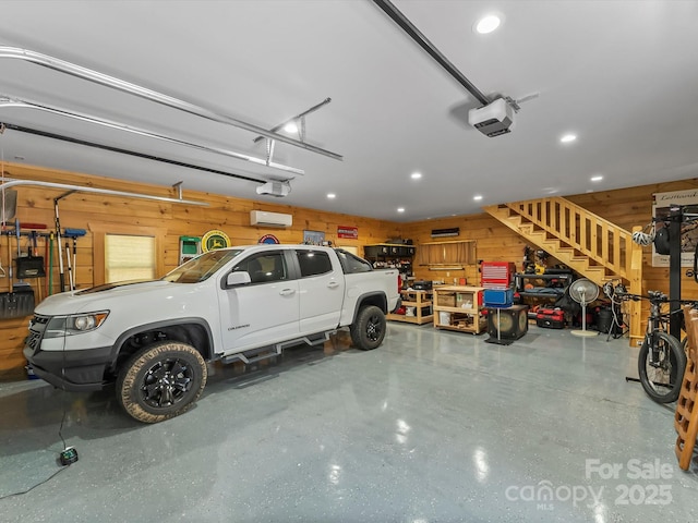 1526 Pisgah Preserve Dr Unit 7-8, Nebo, NC 28761 - garage featuring a garage door opener, wood walls, recessed lighting, and an AC wall unit