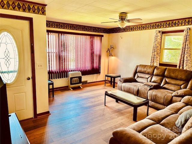 135 Smathers St, Clyde, NC 28721 - living room featuring heating unit, a ceiling fan, wood-type flooring, and baseboards