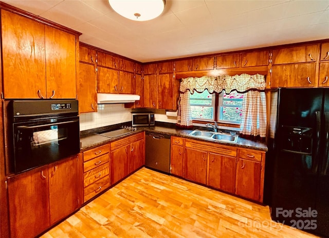 135 Smathers St, Clyde, NC 28721 - kitchen featuring black appliances, a sink, under cabinet range hood, brown cabinets, and dark countertops