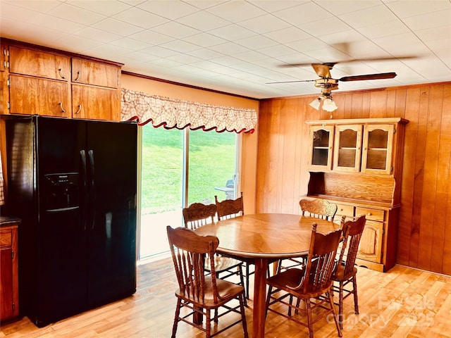135 Smathers St, Clyde, NC 28721 - dining room featuring light wood-style floors, wood walls, ceiling fan, and ornamental molding
