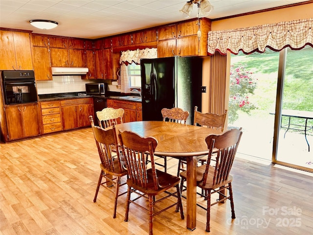 135 Smathers St, Clyde, NC 28721 - dining area featuring light wood-type flooring and ornamental molding