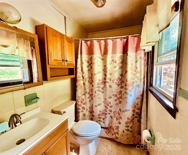 135 Smathers St, Clyde, NC 28721 - bathroom featuring tile walls, plenty of natural light, vanity, toilet, and curtained shower