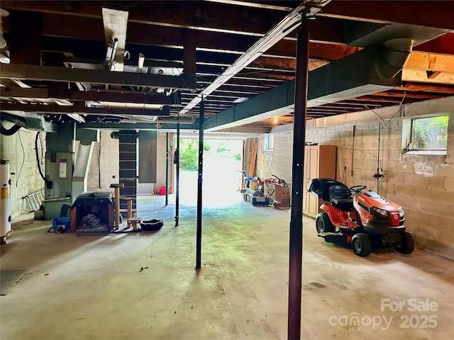 135 Smathers St, Clyde, NC 28721 - garage with heating unit, concrete block wall, and gas water heater