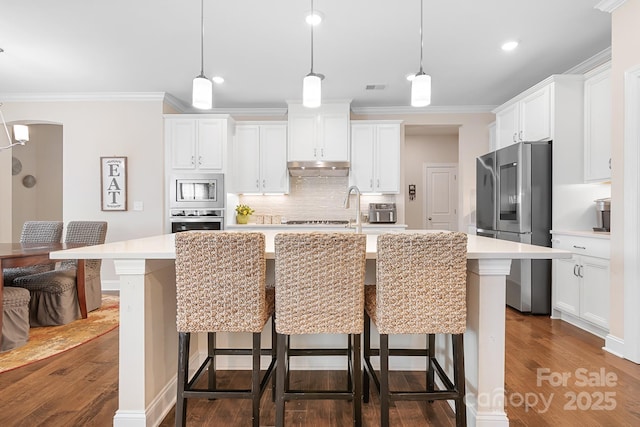 16324 Loch Raven Rd, Huntersville, NC 28078 - kitchen with stainless steel appliances, light countertops, tasteful backsplash, dark wood finished floors, and ornamental molding