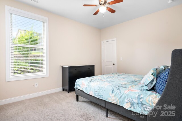 16324 Loch Raven Rd, Huntersville, NC 28078 - bedroom with multiple windows, light colored carpet, and a ceiling fan