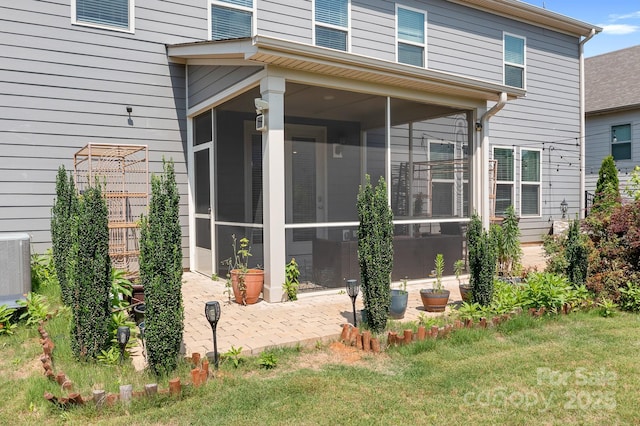 16324 Loch Raven Rd, Huntersville, NC 28078 - back of property with a sunroom, a patio, and a lawn