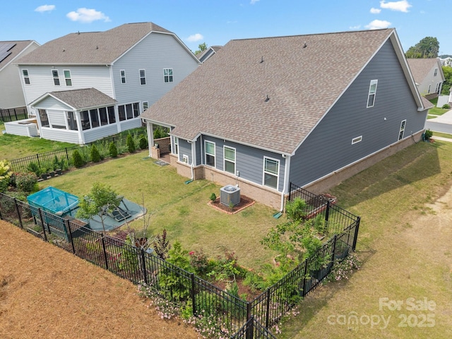 4427 Poplin Grove Dr, Indian Trail, NC 28079 - back of property with a sunroom, roof with shingles, central air condition unit, and brick siding