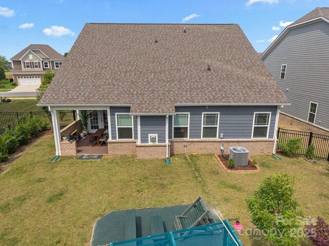 4427 Poplin Grove Dr, Indian Trail, NC 28079 - back of house with brick siding, a patio area, central air condition unit, and roof with shingles