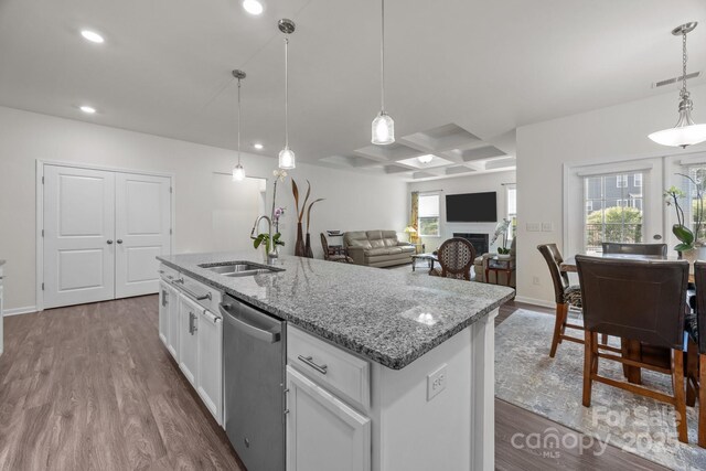4427 Poplin Grove Dr, Indian Trail, NC 28079 - kitchen featuring stainless steel dishwasher, a sink, dark wood-type flooring, light stone countertops, and recessed lighting