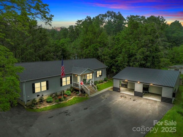 381 US-70 Hwy, Black Mountain, NC 28711 - view of front facade with a garage, crawl space, an outdoor structure, and a wooded view