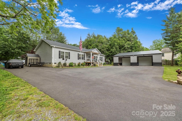 381 US-70 Hwy, Black Mountain, NC 28711 - view of front facade with an outdoor structure, a detached garage, and crawl space
