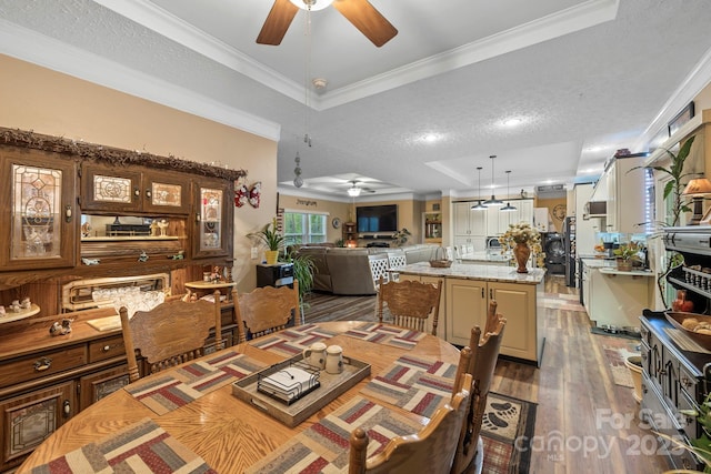 381 US-70 Hwy, Black Mountain, NC 28711 - dining area featuring ceiling fan, a raised ceiling, a textured ceiling, wood finished floors, and ornamental molding
