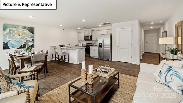 5912 Faron Way, Charlotte, NC 28262 - living area with recessed lighting, dark wood finished floors, and baseboards