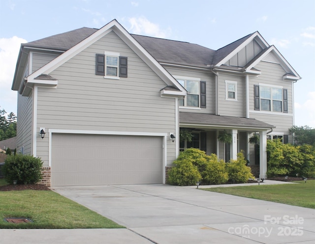 858 Oak Manor Dr SE, Concord, NC 28025 - view of front of house featuring concrete driveway, an attached garage, and board and batten siding