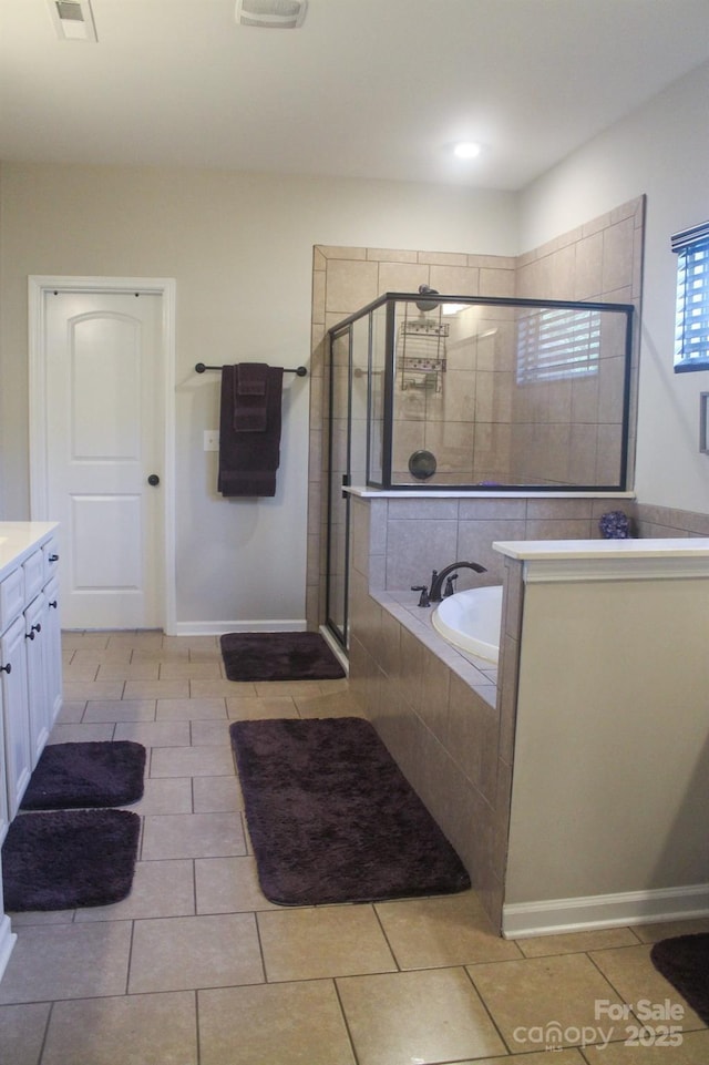 858 Oak Manor Dr SE, Concord, NC 28025 - full bathroom with a shower stall, vanity, a garden tub, and tile patterned flooring