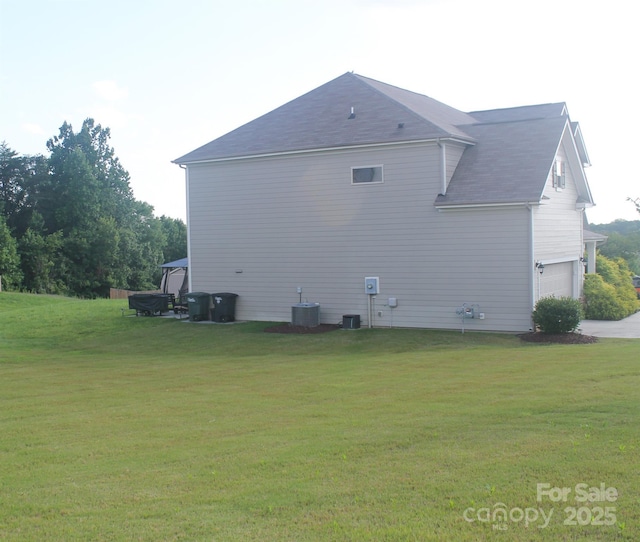 858 Oak Manor Dr SE, Concord, NC 28025 - view of side of property featuring an attached garage, a lawn, and concrete driveway