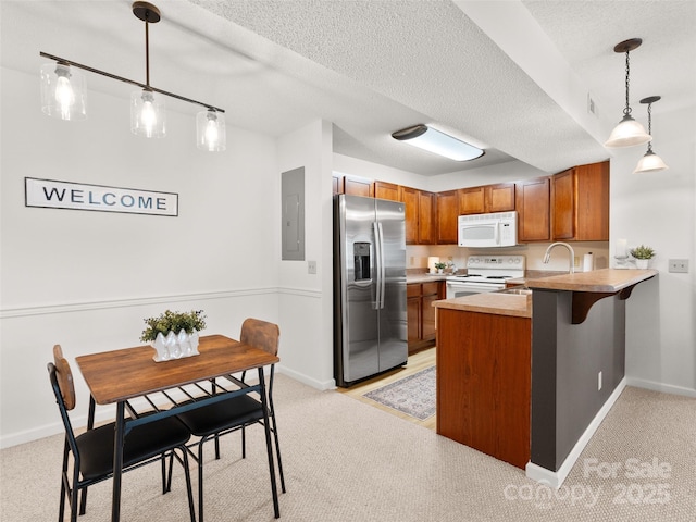 91 Morningside Ln, Hendersonville, NC 28792 - kitchen featuring white appliances, brown cabinets, light colored carpet, and a textured ceiling