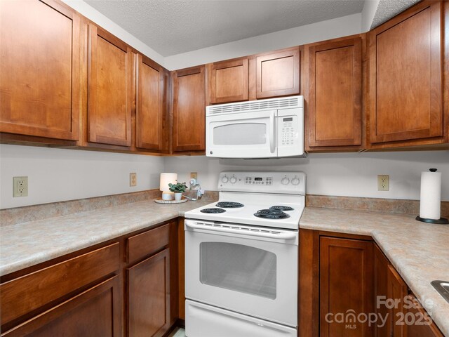 91 Morningside Ln, Hendersonville, NC 28792 - kitchen with white appliances, brown cabinets, and light countertops