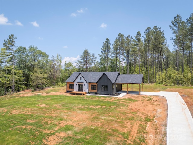 1872 Piney Mountain Church Rd, Bostic, NC 28018 - view of front of house featuring board and batten siding, driveway, and a front lawn