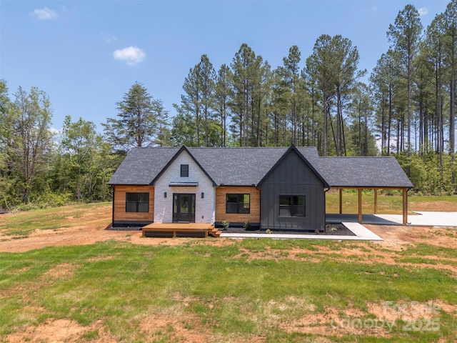 1872 Piney Mountain Church Rd, Bostic, NC 28018 - modern inspired farmhouse with board and batten siding, a front lawn, and a wooden deck
