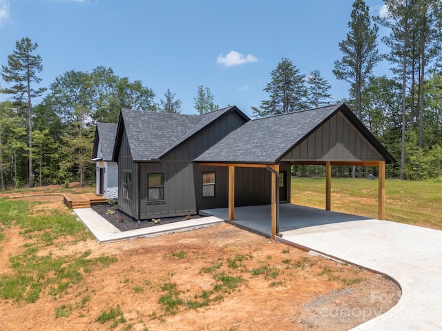 1872 Piney Mountain Church Rd, Bostic, NC 28018 - view of front of home featuring roof with shingles, an attached carport, concrete driveway, and a front yard