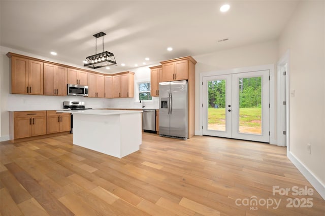 1872 Piney Mountain Church Rd, Bostic, NC 28018 - kitchen with stainless steel appliances, recessed lighting, light countertops, light wood-style floors, and a center island
