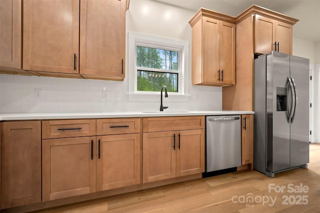 1872 Piney Mountain Church Rd, Bostic, NC 28018 - kitchen with appliances with stainless steel finishes, a sink, light wood finished floors, and tasteful backsplash