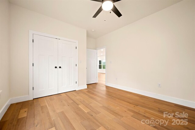 1872 Piney Mountain Church Rd, Bostic, NC 28018 - unfurnished bedroom with light wood-style floors, baseboards, a closet, and ceiling fan