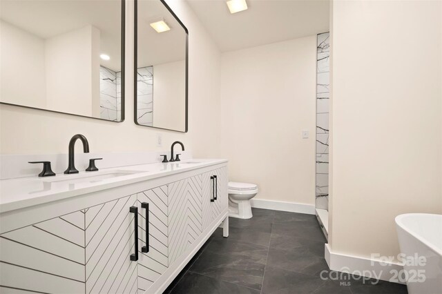 1872 Piney Mountain Church Rd, Bostic, NC 28018 - full bath featuring double vanity, toilet, baseboards, and a freestanding bath
