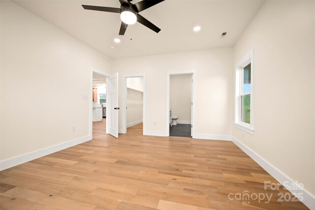 1872 Piney Mountain Church Rd, Bostic, NC 28018 - unfurnished bedroom featuring recessed lighting, a spacious closet, light wood-type flooring, baseboards, and connected bathroom