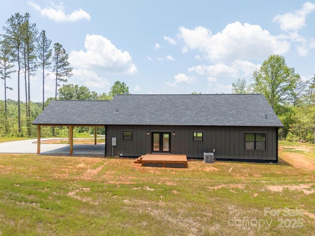 1872 Piney Mountain Church Rd, Bostic, NC 28018 - rear view of property with french doors, cooling unit, a lawn, a shingled roof, and board and batten siding